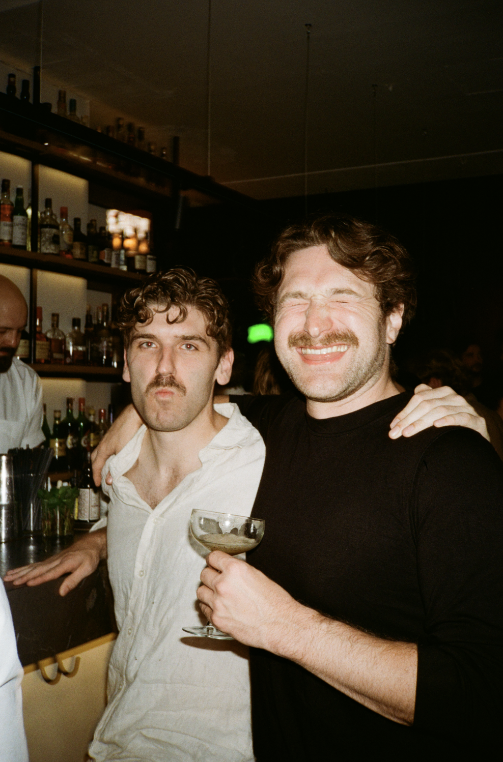 Two friends at a bar